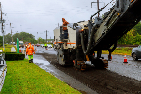 Road works asphalt removing machine loading powdered asphalt on the truck Asphalt removing